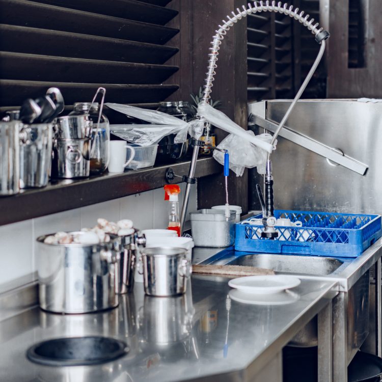 Clean outside restaraunt kitchen full of dishes and tableware